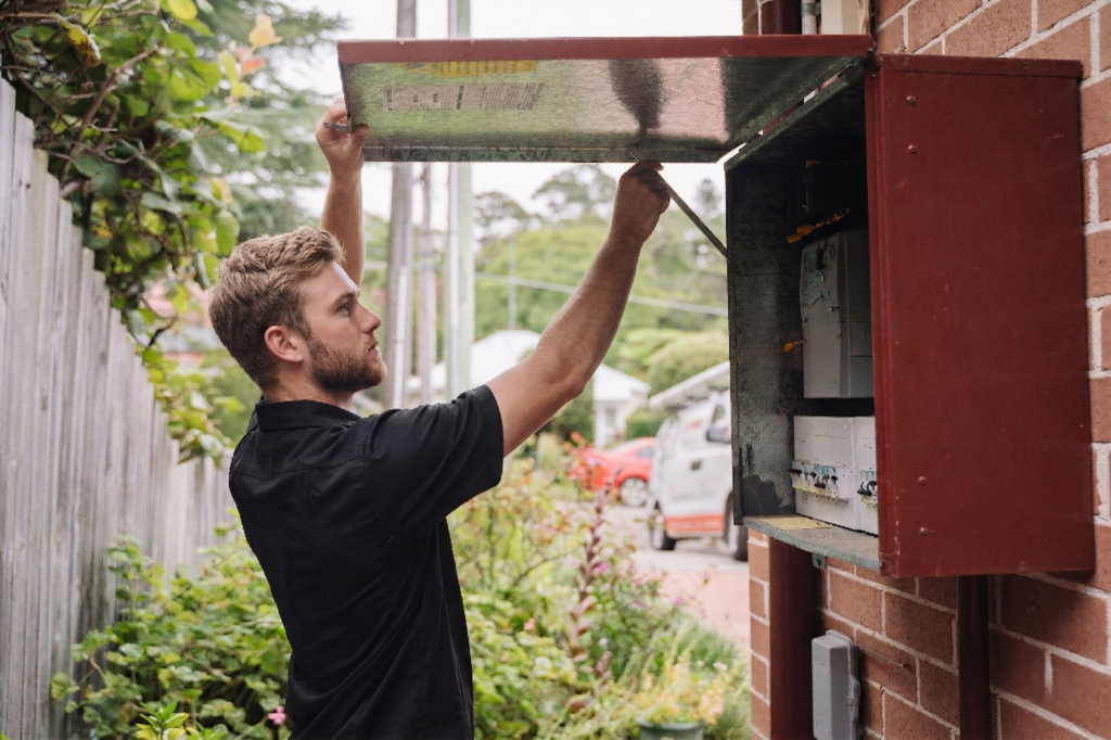 Electrician installing downlights in a Chippendale home